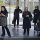 Women dressed in “hijab”wait for a bus in central Tehran, Iran.